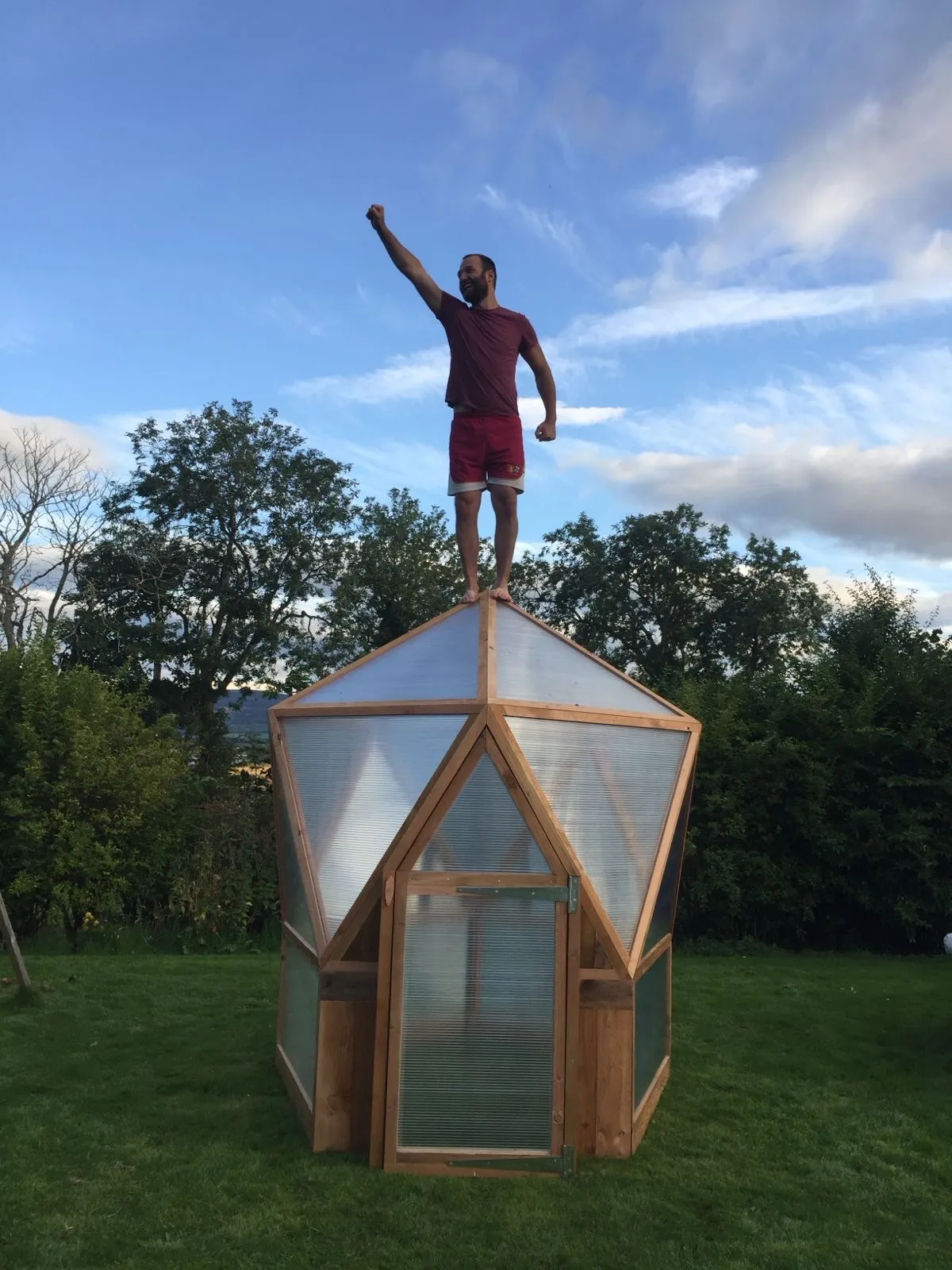 Highland Domes geodesic greenhouse installed in a Scottish garden with polycarbonate panels